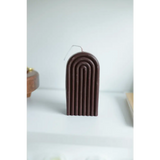 Brown arch-shaped candle with ridged patterns for a cute Petite Rainbow Candle vibe
