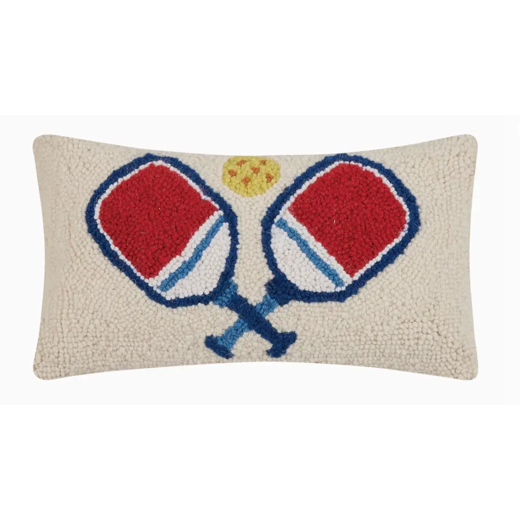 Decorative throw pillow showcases two crossed pickleball paddles in red and blue