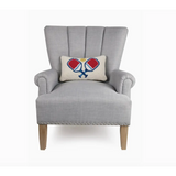 Gray armchair with wooden legs showcasing two crossed paddles throw pillow