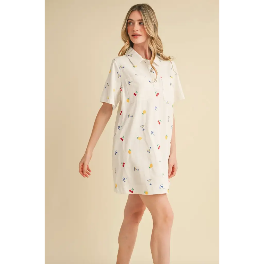 White collared mini dress with colorful fruit and drink embroidery for a fun picnic look