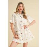 Women’s white collared mini dress with colorful fruit and drink pattern for a fun picnic look