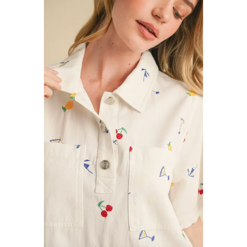 White collared mini dress with colorful fruit and cocktail embroidery for a fun summer look