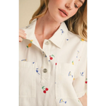 White collared mini dress with colorful fruit and cocktail embroidery for a fun summer look