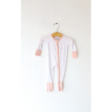 White baby onesie with pink trim, perfect bamboo baby sleeper for comfy naps