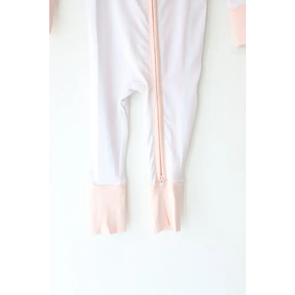 Pink striped bamboo baby sleeper with footed design and zipper for comfy naps