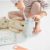 Disposable diaper opening with a bear, showcasing pretend play bandages nearby