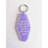 Purple acrylic retro motel keychain promoting peace and love vibes in style