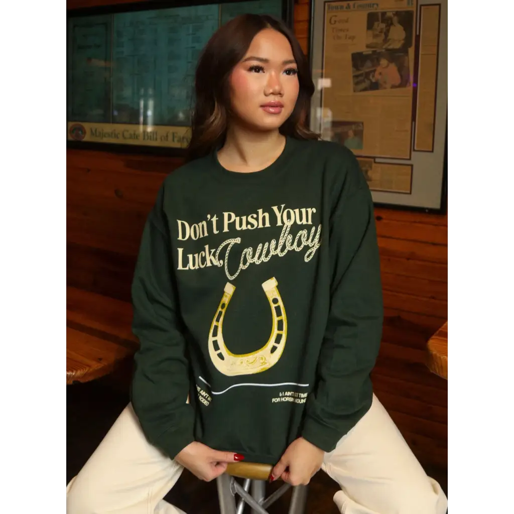 Green sweatshirt with horseshoe design, perfect stylish women’s clothes for moms