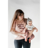 Parent and baby in matching organic cotton graphic t-shirts in pink and gray
