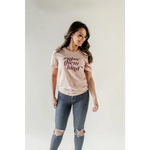 Pink Raise them Kind graphic t-shirt in organic cotton paired with distressed blue jeans