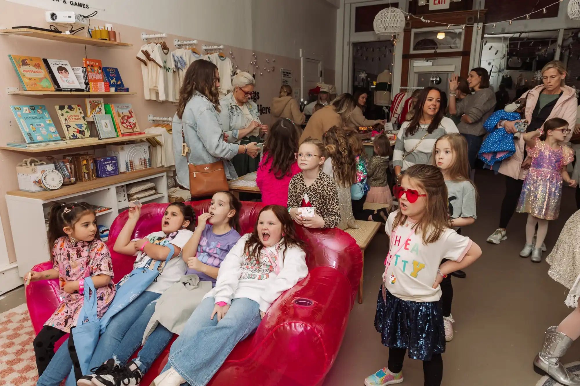 Red leather couch filled with children wearing 3D glasses.