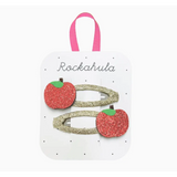Two Rosy Red Glitter Apple Hair Clips on a Rockahula card with gold bases
