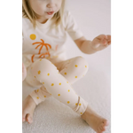 White pajama set featuring orange palm trees and yellow polka dots for Shine Bright Star leggings