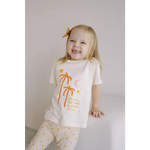 Joyful toddler in Shine Bright Star Flexible Lightweight Leggings with palm trees and polka dots