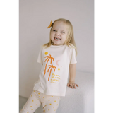 Joyful toddler in Shine Bright Star Flexible Lightweight Leggings with palm trees and polka dots