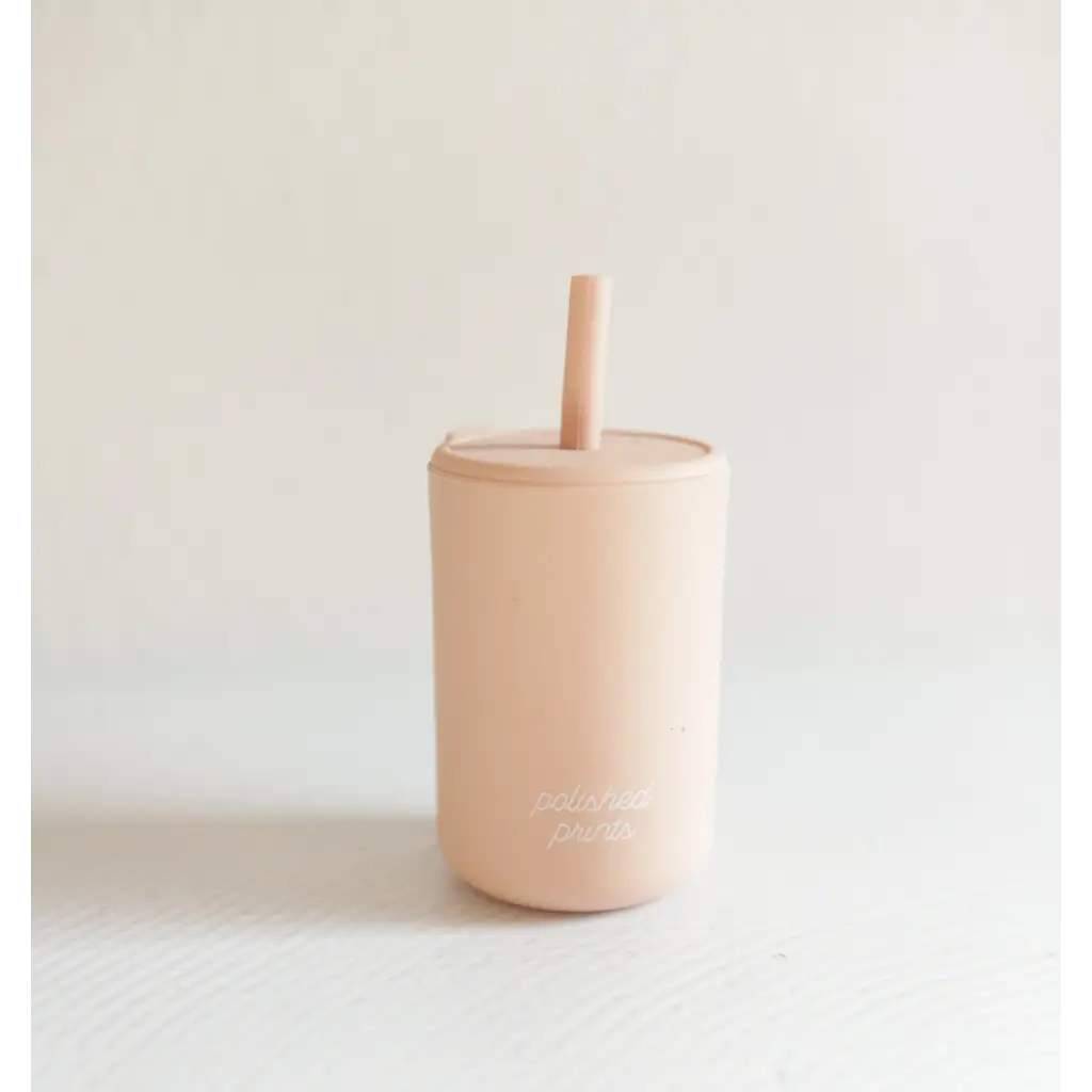 Peachy-pink mini silicone straw cup perfect for little hands to sip in style