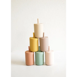 Six pastel cylindrical candles stacked in a pyramid by Pastel Mini Silicone Straw Cups for Kids