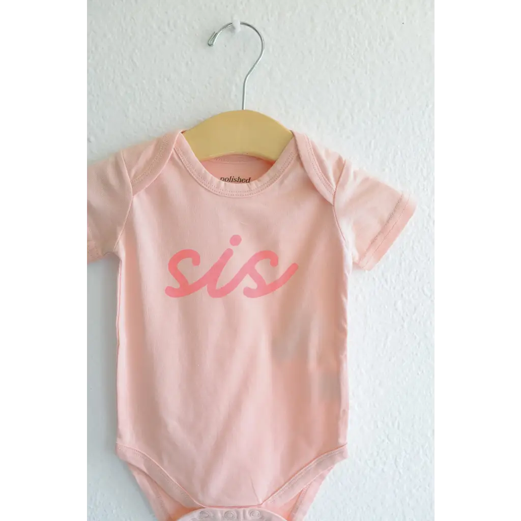 Pink sis organic cotton onesie for baby sister making her debut in style