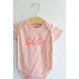 Pink sis organic cotton onesie for baby sister making her debut in style