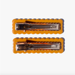Two cute orange Smart Cookie Hair Clips with metallic clasps and scalloped edges