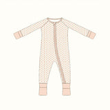 Cute baby sleeper with diagonal zipper, pink cuffs, and subtle pattern, perfect bamboo baby sleeper