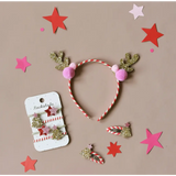 Festive reindeer antler headband with pink pom-poms for fun strippy Christmas style