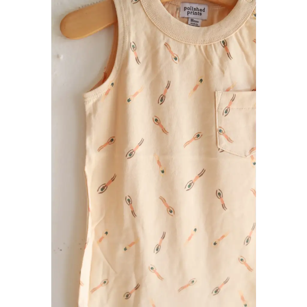 Cream-colored sleeveless dress with tennis print perfect for a super soft pocket playsuit vibe