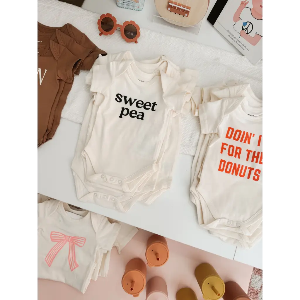 Cute Sweet Pea Baby Onesies made from organic cotton with polished prints