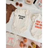 Cute Sweet Pea Baby Onesies made from organic cotton with polished prints