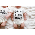 Two cute baby onesies in organic cotton with FAN FAVORITE and TALK OF THE TOWN text