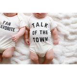 Two cute baby onesies in organic cotton with FAN FAVORITE and TALK OF THE TOWN text