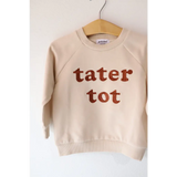 Cream Tater Tot Kids Pullover Sweatshirt on a hanger with cute brown lettering
