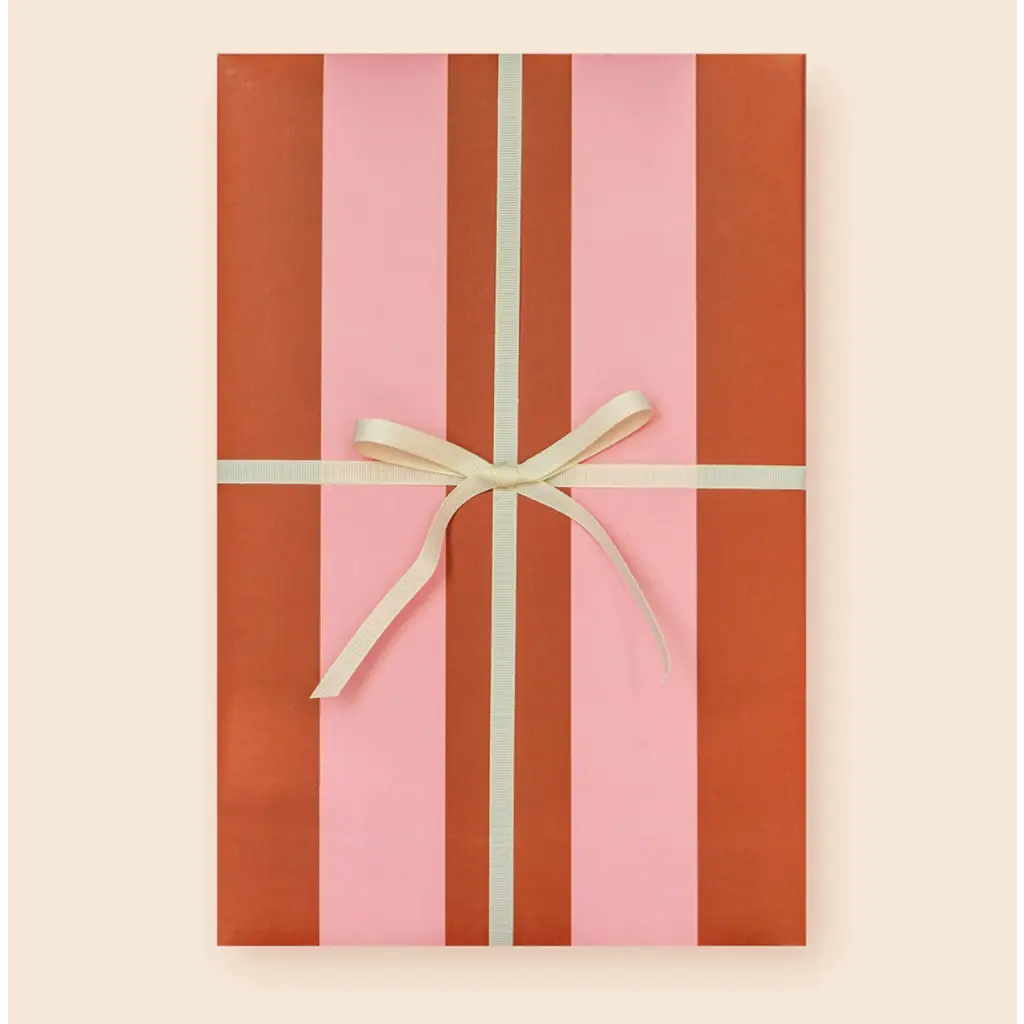 Cute pink and red striped gift box with cream bow showcasing modern wrapping paper