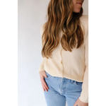 Long wavy brown hair with caramel highlights in The Annie Cardigan Sweater outfit