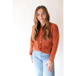 Rust-colored Annie Cardigan Sweater styled with light wash jeans for a chic look