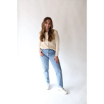 Light-wash mom jeans, cream sweater, and white sneakers with Annie Cardigan Sweater