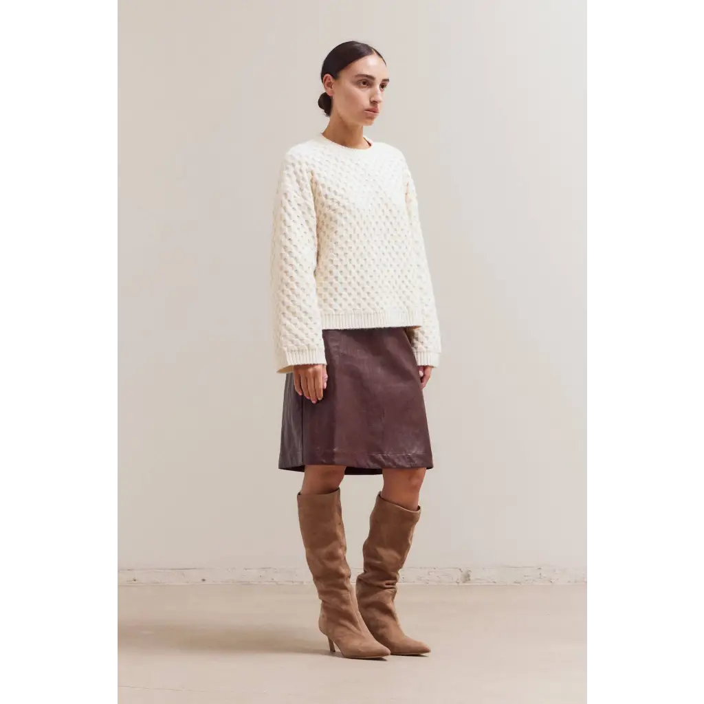 Cream Betsy Crew Knit sweater with brown leather skirt and tan boots