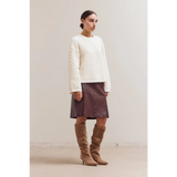 Cream Betsy Crew Knit sweater with brown leather skirt and tan boots