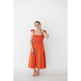 Bright orange day dress with tied straps and smocked bodice for a fun summer look