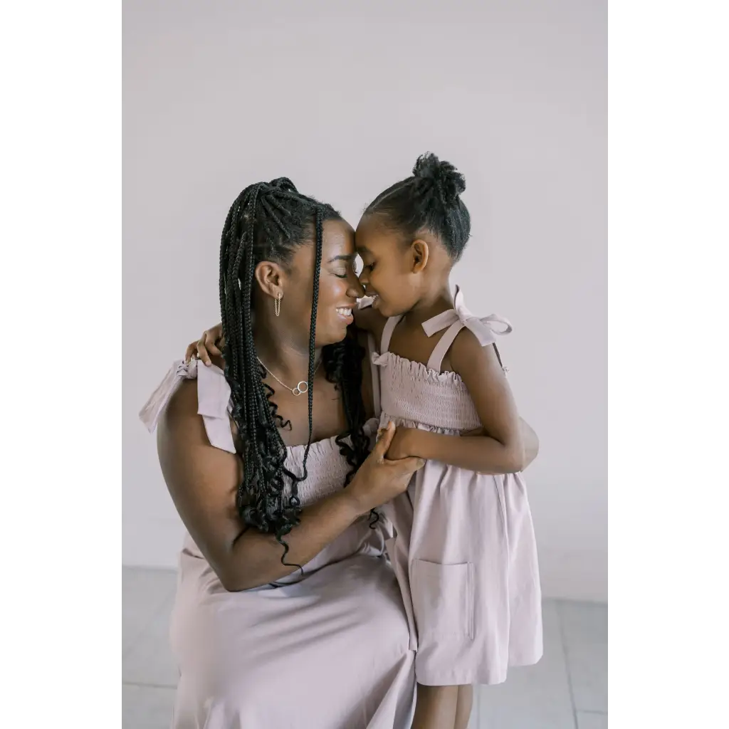 Parent and child share a sweet moment in the Lilac Day Dress with Ruffled Straps