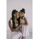 Parent and child share a sweet moment in the Lilac Day Dress with Ruffled Straps