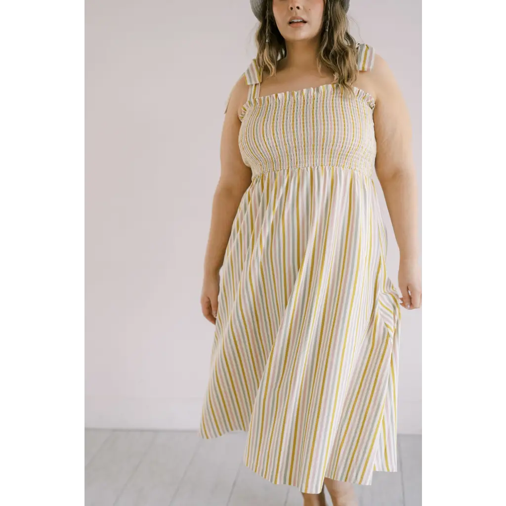 Striped day dress with smocked bodice and spaghetti straps for a chic summer look
