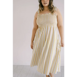 Striped day dress with smocked bodice and spaghetti straps for a chic summer look