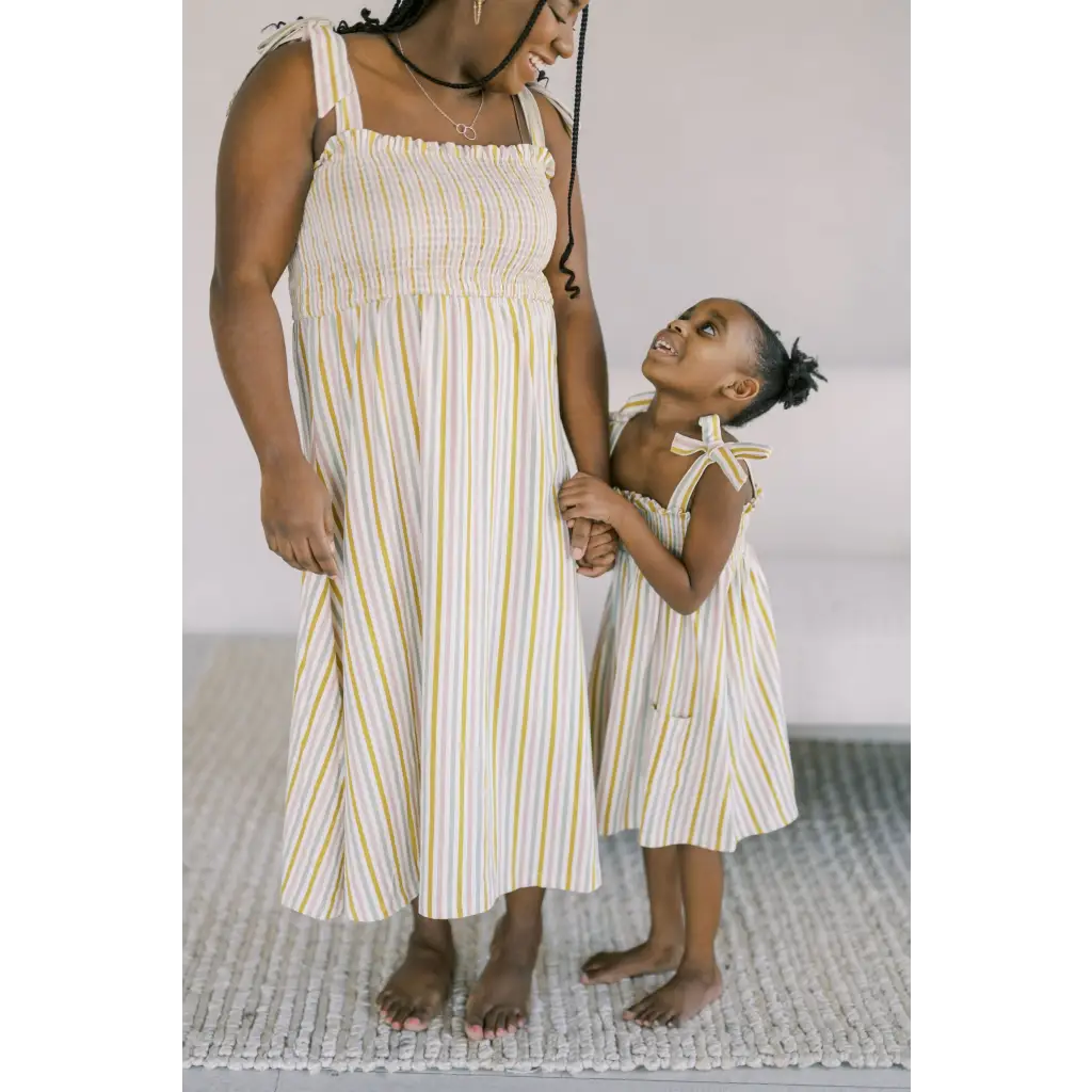 Matching striped sundresses with yellow accents perfect for a stylish day dress outing