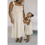 Matching striped sundresses with yellow accents perfect for a stylish day dress outing