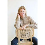 Cane-backed wooden chair with a rattan seat complements the Ellen Henley sweater in classic style
