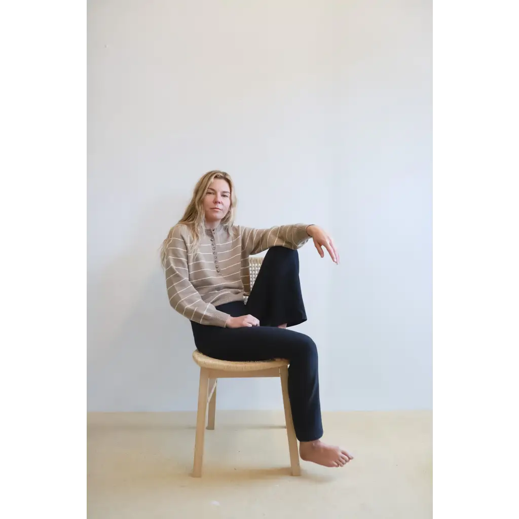 Person in an Ellen Henley Sweater, beige and white stripes, rocking classic style