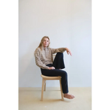 Person in an Ellen Henley Sweater, beige and white stripes, rocking classic style
