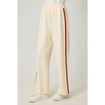 Cream tracksuit pants with red side stripes and elastic waistband, perfect for casual wear