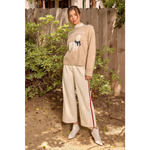 Beige and white tracksuit pants with red stripe, soft material, elastic waistband, polished prints